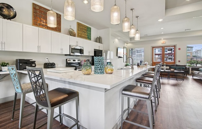 A kitchen with a white counter top and bar stools.