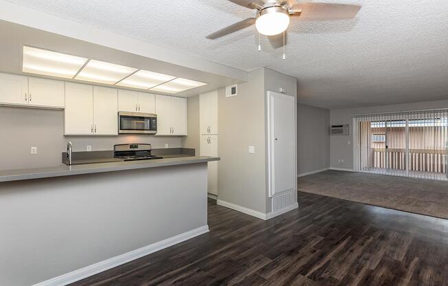 a kitchen area with a building in the background