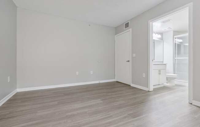 an empty living room with white walls and wood flooring at Pembroke Pines Landings, Pembroke Pines 