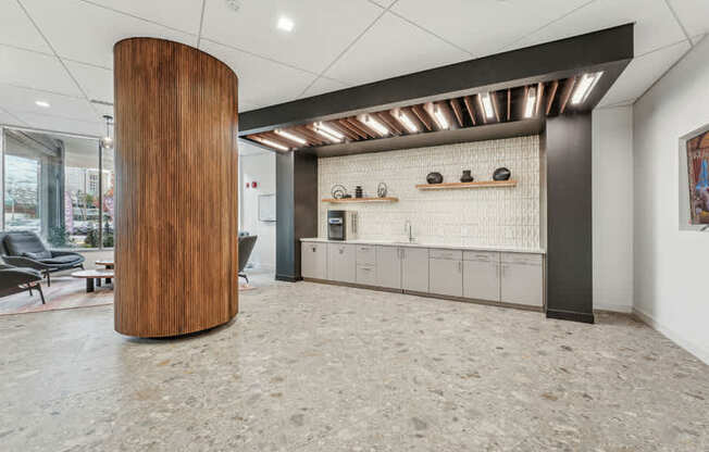 A modern office lobby with a wooden column and a row of lockers.