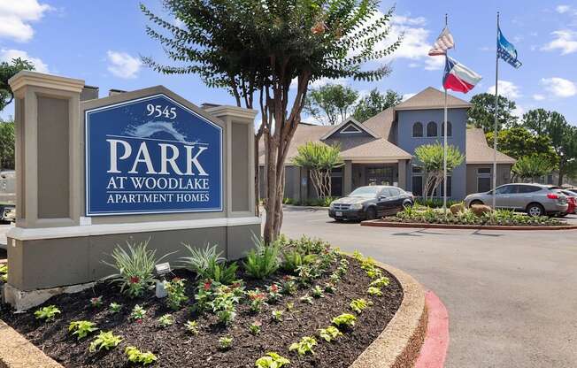 a parking lot with a sign that says park at woodlawn apartments