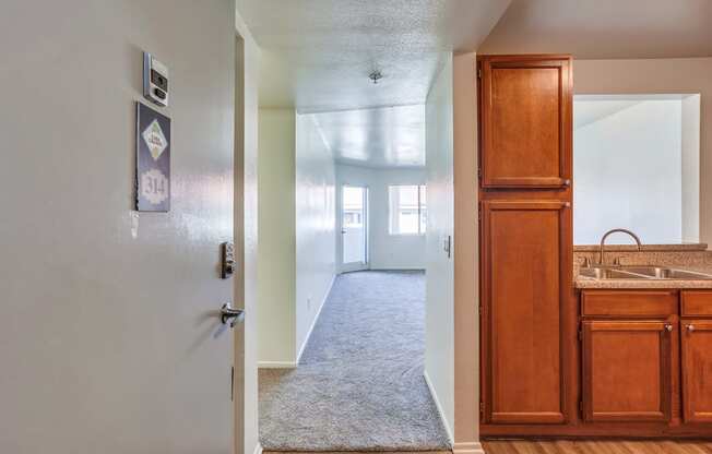 a view from the living room into the kitchen and dining room