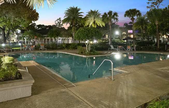 Community Swimming Pool with Pool Furniture at Fountains at Lee Vista Apartments in Orlando, FL.