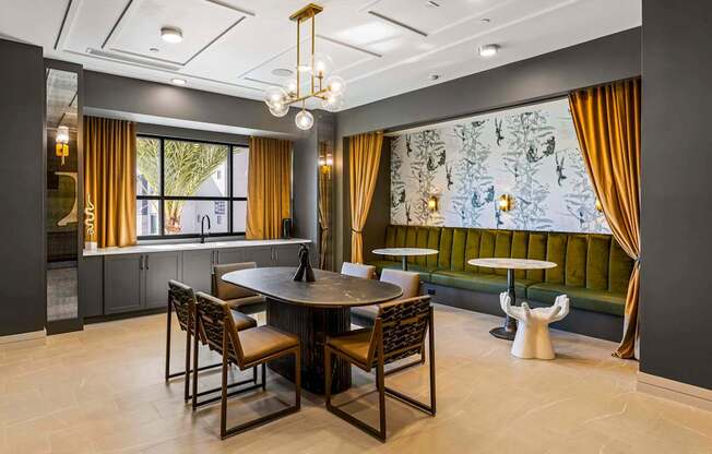 A dining room with a round table and chairs.