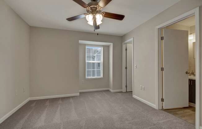 Bedroom, carpet, large window, ceiling fan