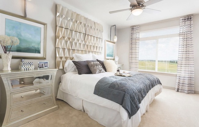 Furnished model bedroom with plush carpet