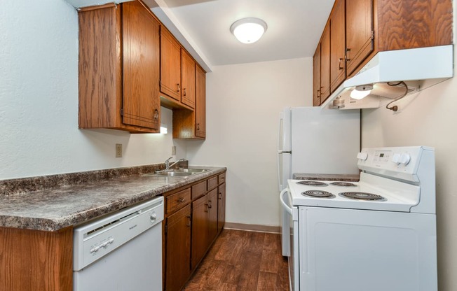 White Bear Lake, MN White Bear Terrace Apartments.  a kitchen with white appliances and wooden cabinets