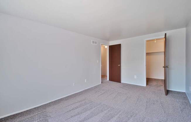 Comfortable bedroom with ample closet space at Farmbrooke Manor Apartments Clinton Township MI