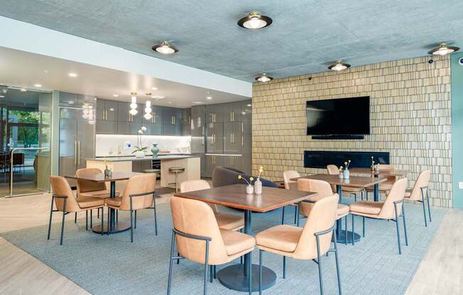 A modern dining room with a fireplace and a television.