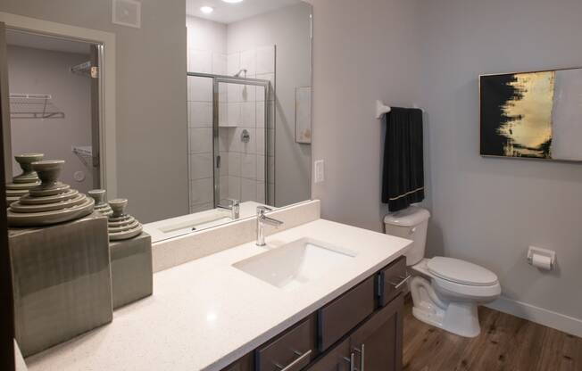 a bathroom with a toilet sink and shower