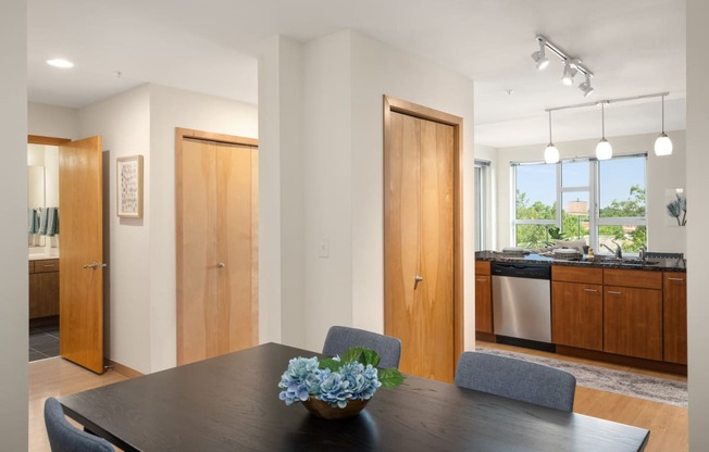 a dining room with a table and chairs and a kitchen