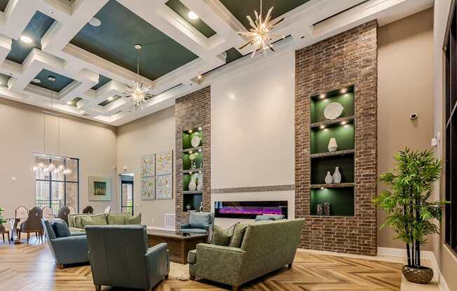 A living room with a fireplace and a brick wall.
