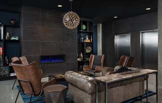 a living room with a couch and chairs and a table