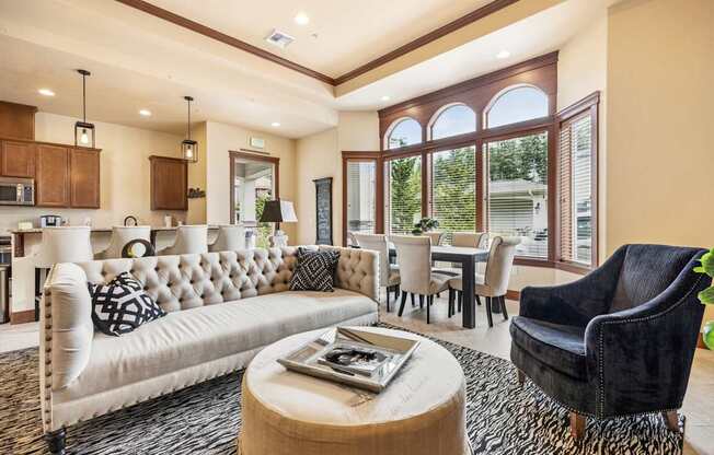 A living room with a white sofa and a black chair.
