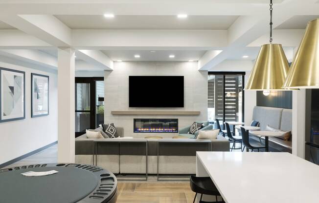 a kitchen and living room with a fireplace and a tv