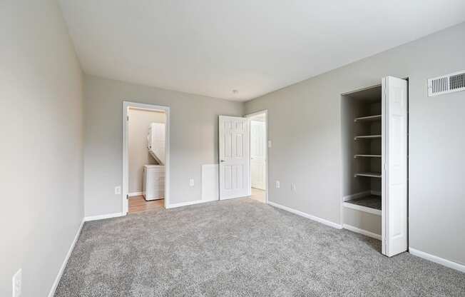 an empty bedroom with carpet and a closet at ReNew Odenton