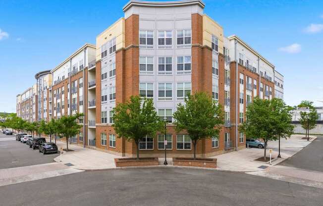 A large multi-story building with a parking lot in front.