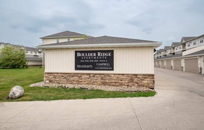 a building with a sign that says boulder river apartments