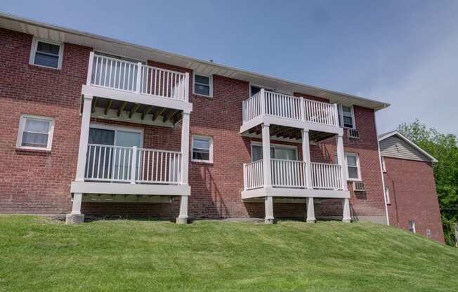 a brick apartment building with two sets of balconies