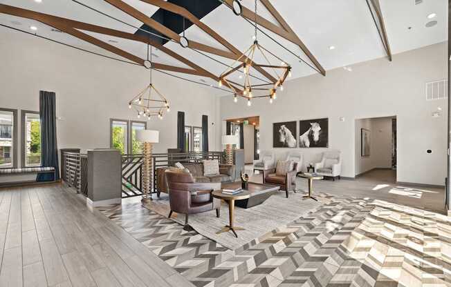 A modern living room with a large rug and a wooden floor.