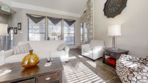 a living room filled with furniture and a large window