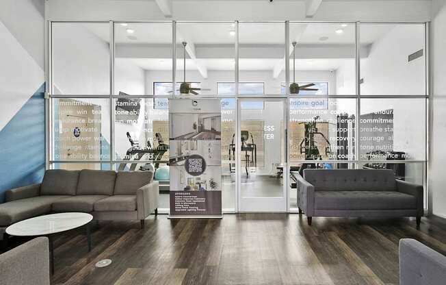 A modern office lobby with a glass wall and a staircase.