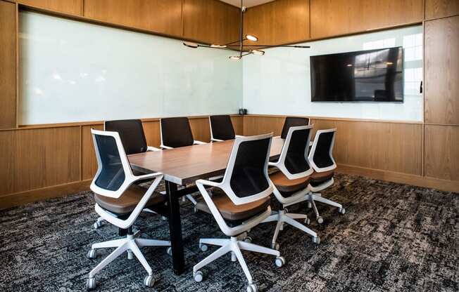 a small conference room with a table and chairs