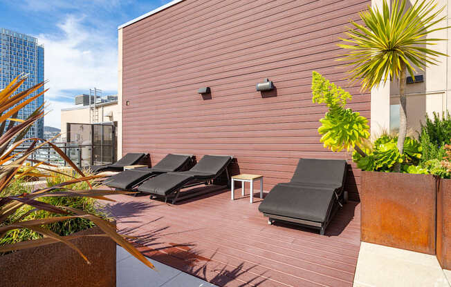 A patio with black chairs and a table.