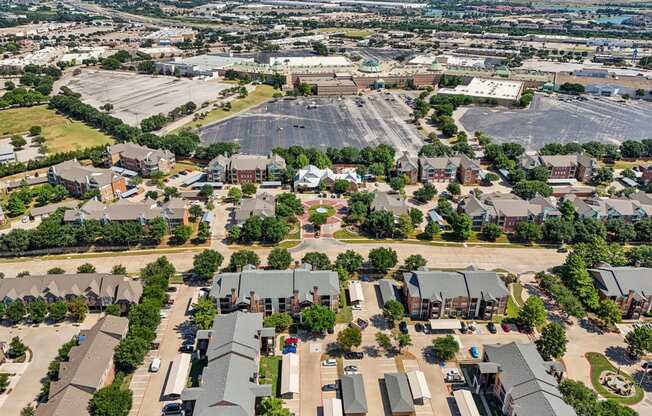 an aerial view of a suburb of a city with a large parking lot