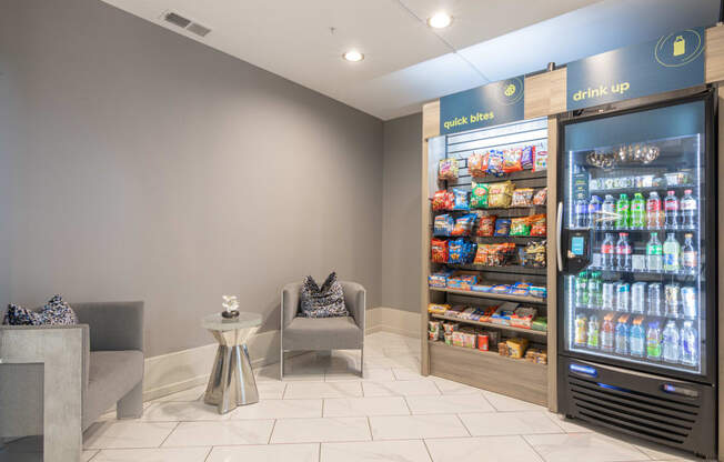 the lobby of a convenience store with refrigerators and chairs