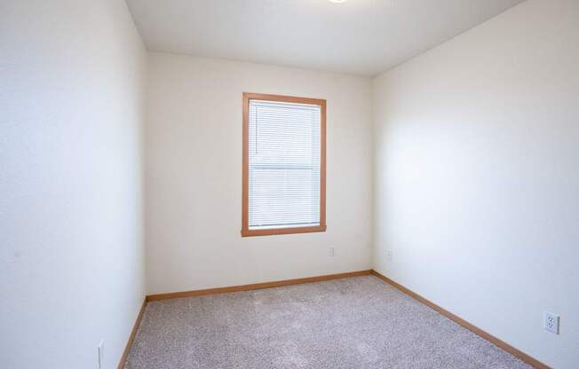 A room with a window and carpeted floor. West Fargo, ND Sheyenne Terrace Townhomes