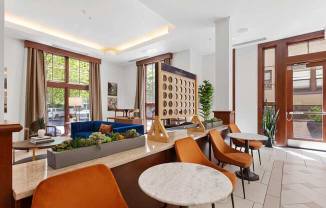 a living room with tables and chairs and a blue couch