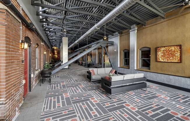 the lobby of a building with couches and a rug at The Knights @ 506 Delaware Apartments, Buffalo, NY 14202