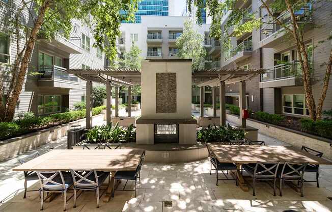 A courtyard with a table and chairs and a fountain in the middle.