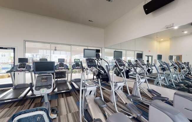 a room filled with lots of cardio equipment