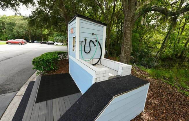 a bench with a hose on it next to a road  at Ocean Park, Jacksonville Beach, FL, 32250