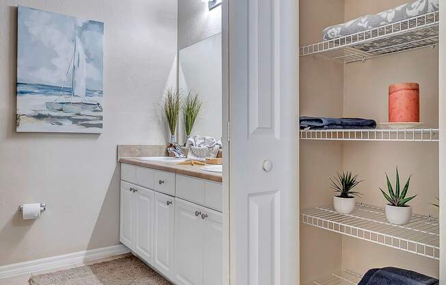 bathroom with tile floor and linen closet at Bermuda Estates Apartments in Ormond Beach, FL