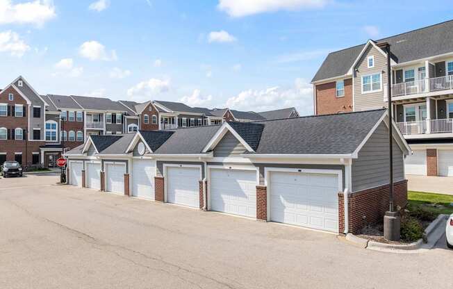 A row of houses with garages in front.