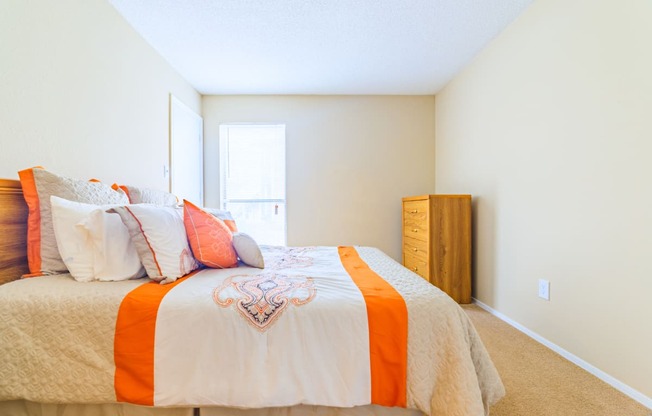 Forest Lake at Oyster Point in Newport News VA interior view of bedroom with orange and white linens