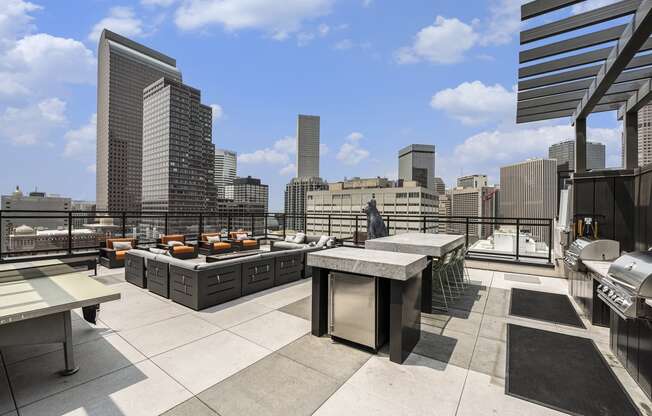 a rooftop terrace with tables and a view of the city