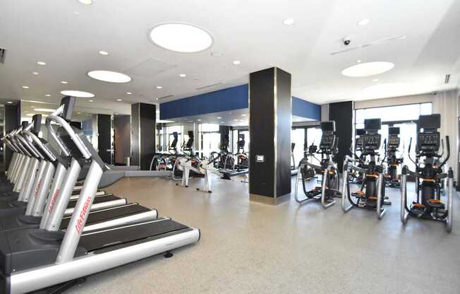 A gym with treadmills and exercise bikes.