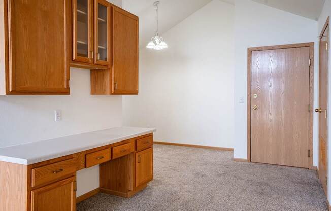 A room with a desk and a cabinet. Fargo, ND Summit Point Apartments