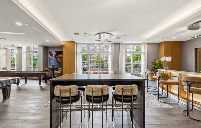 A modern kitchen with a bar area and seating.