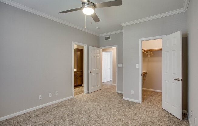 View of Bedroom with Ceiling Fan, Carpet, and Closet at Raveneaux Apartments