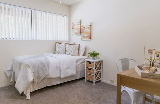 A bedroom in a model apartment at Cranbrook.