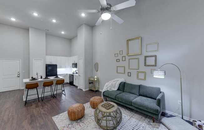 a living room with a couch and a kitchen with a table and chairs