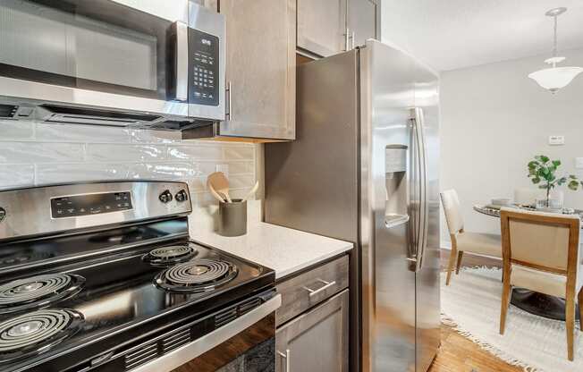 a kitchen with stainless steel appliances and a stove and a refrigerator at Reserve of Jackson Apartment Homes, Jackson, Mississippi