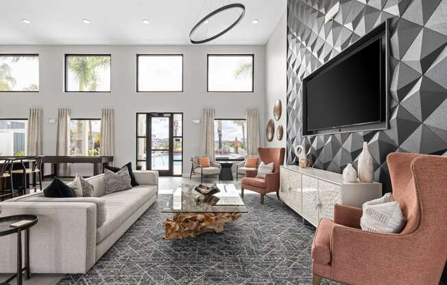 a living room with couches and chairs and a television at The Sophia, Venice, FL, 34275