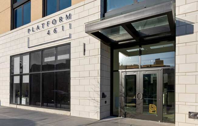 a brick building with a glass door and a sign that reads platform 466 at Platform 4611, Chicago
