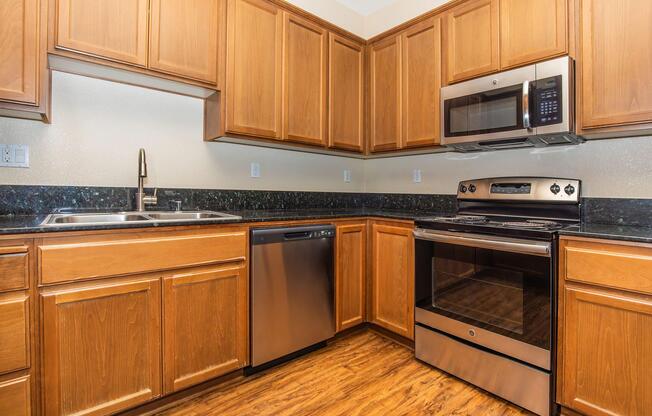 a kitchen with stainless steel appliances and wooden cabinets